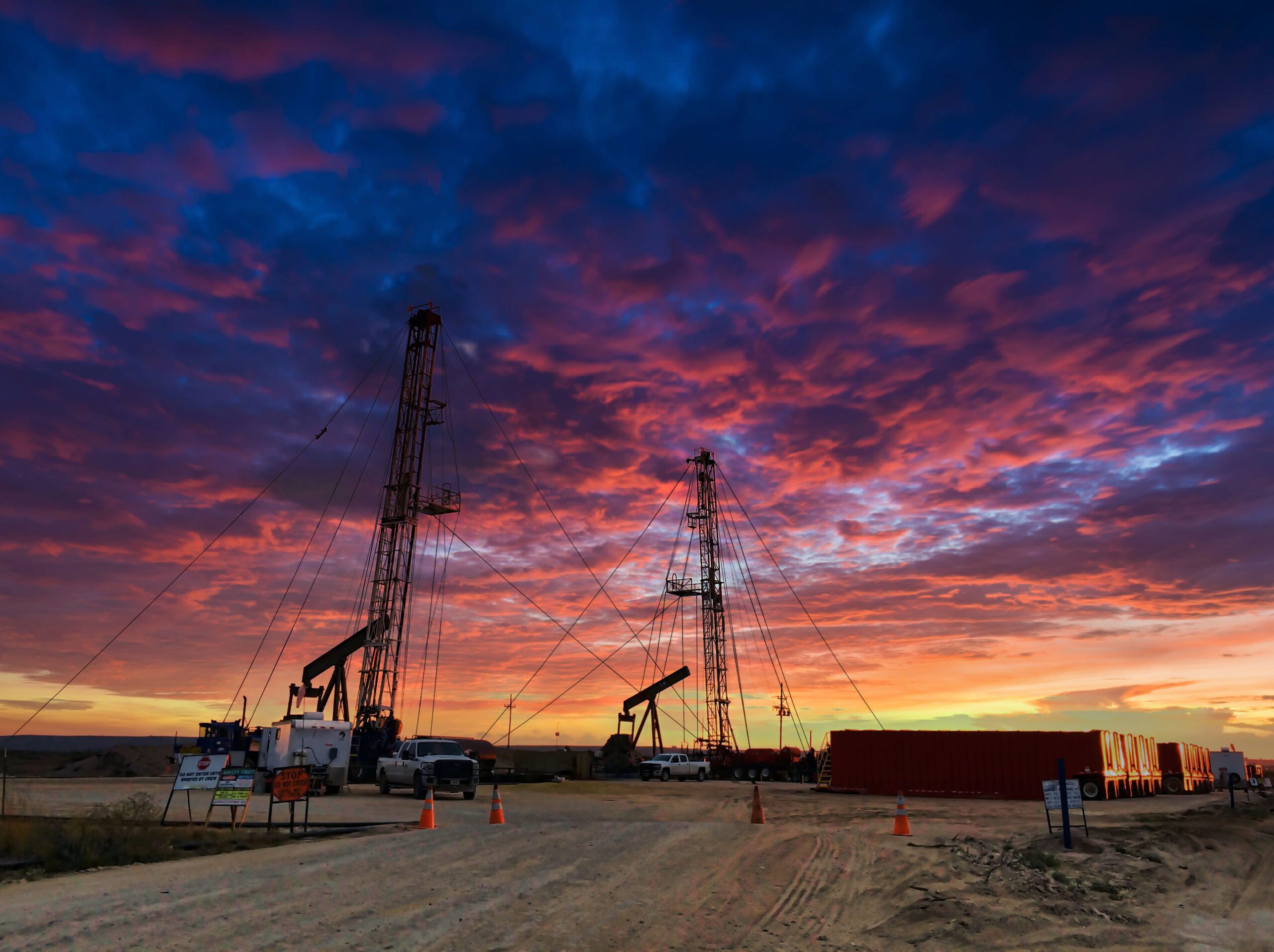 Two Workover Rigs at Sunset in Texas